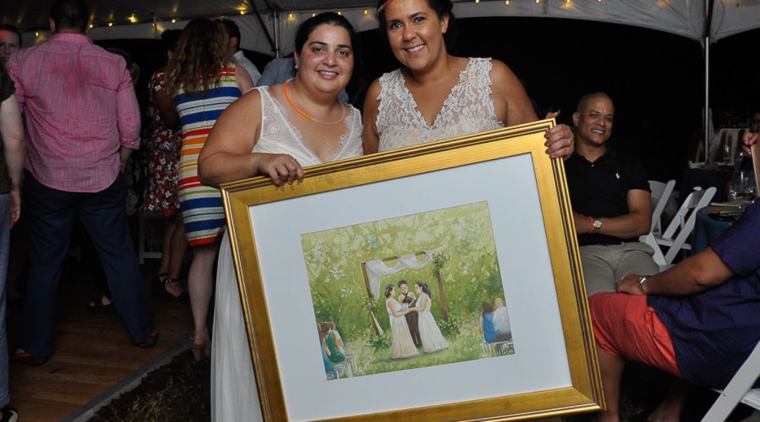 Brides pose next to a painting of their ceremony by LIve Wedding Painting artist Tesh Parekh.